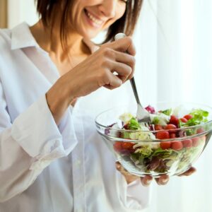 Woman eating a large salad