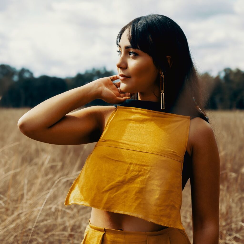 Person wearing yellow crop top and bottoms