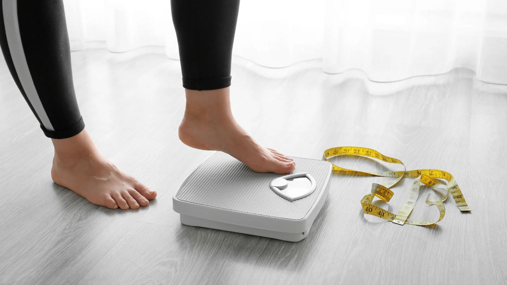 Closeup of woman stepping onto a scale